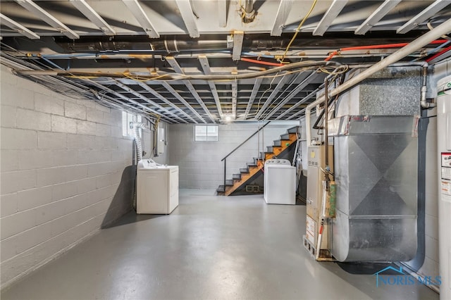 basement with heating unit and washing machine and clothes dryer