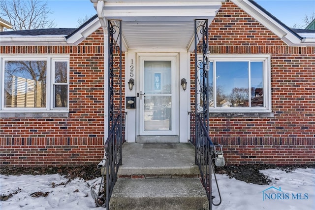 view of snow covered property entrance