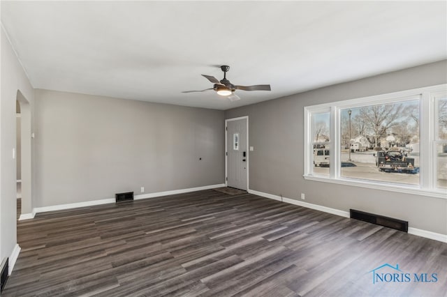 interior space featuring dark wood-type flooring and ceiling fan