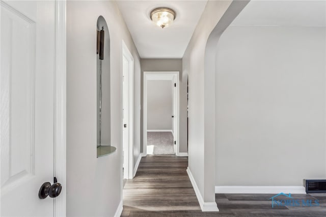 corridor featuring dark hardwood / wood-style floors