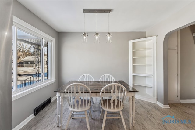 dining space with light hardwood / wood-style floors