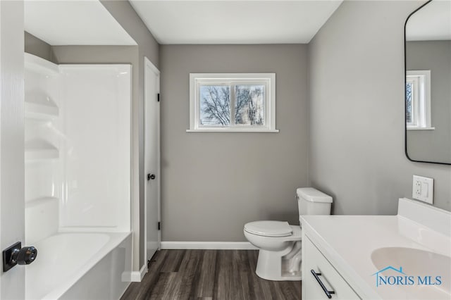 full bathroom featuring vanity, hardwood / wood-style floors, shower / tub combination, and toilet