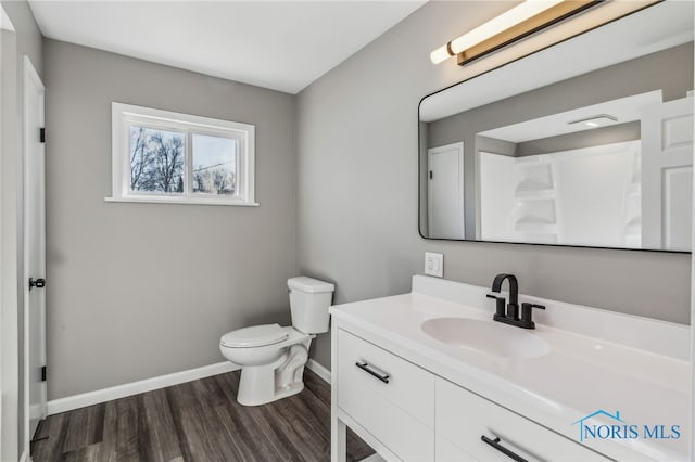 bathroom with vanity, hardwood / wood-style floors, and toilet