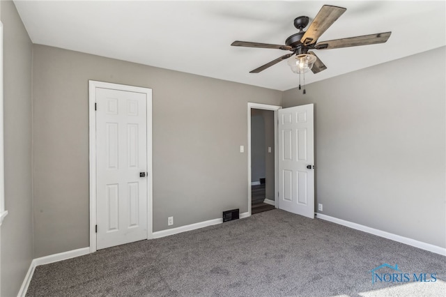 unfurnished bedroom with ceiling fan and carpet