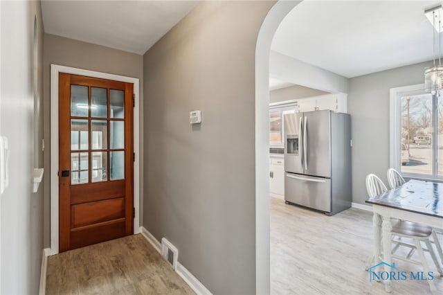 doorway to outside featuring plenty of natural light and light hardwood / wood-style flooring