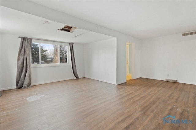 spare room featuring light hardwood / wood-style floors