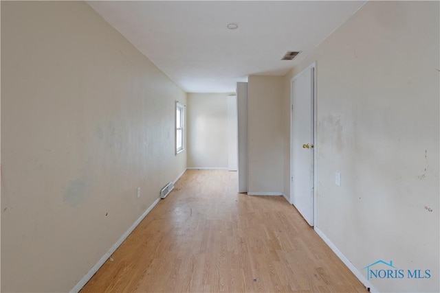 corridor with light hardwood / wood-style flooring