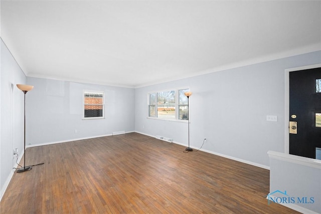 unfurnished room with dark wood-type flooring