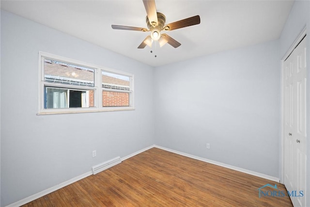 spare room with wood-type flooring and ceiling fan