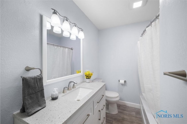 bathroom with vanity, wood-type flooring, toilet, and walk in shower