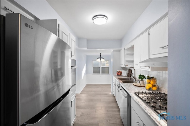 kitchen with white cabinetry, sink, decorative light fixtures, and appliances with stainless steel finishes