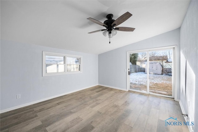 unfurnished room featuring wood-type flooring, lofted ceiling, and ceiling fan