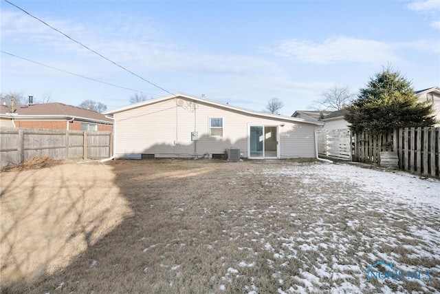 snow covered house featuring central AC