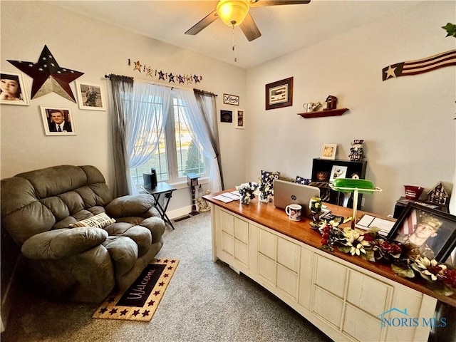 carpeted home office featuring ceiling fan