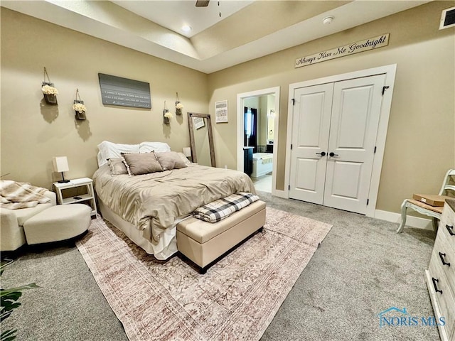 carpeted bedroom featuring connected bathroom, a closet, and ceiling fan