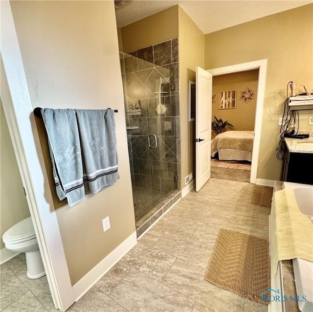 bathroom with vanity, a shower with shower door, and toilet