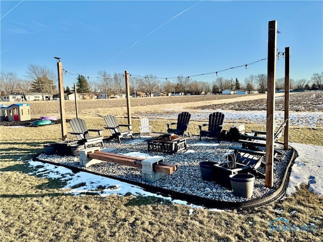 view of yard with a fire pit