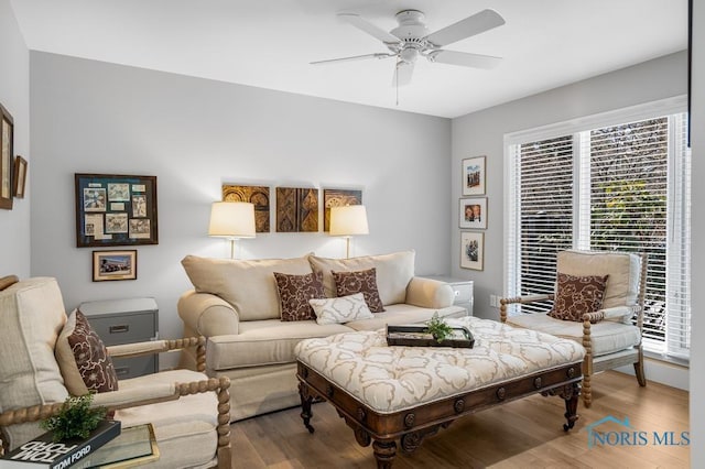 living room with wood-type flooring and ceiling fan