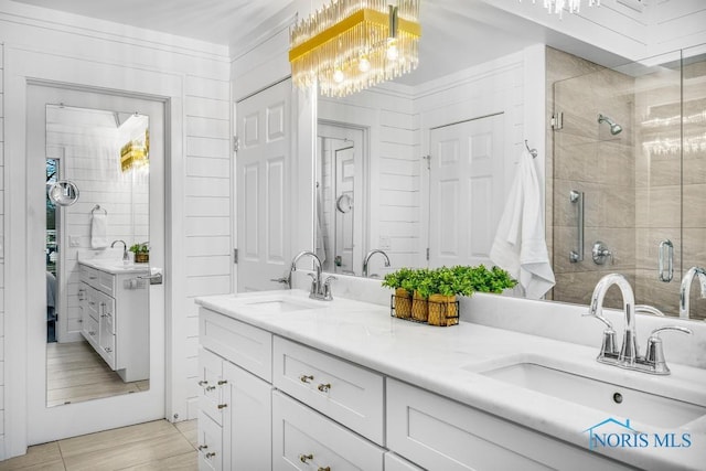 bathroom featuring vanity and a shower with door