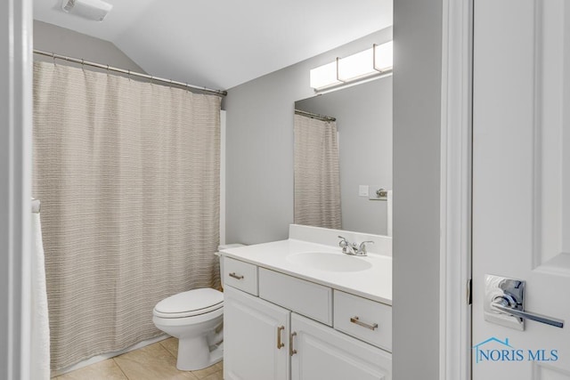 bathroom with vanity, vaulted ceiling, tile patterned floors, and toilet