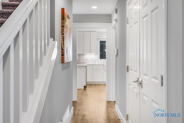 hallway with light wood-type flooring