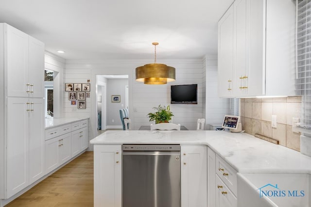 kitchen with dishwasher, white cabinets, light wood-type flooring, and decorative light fixtures