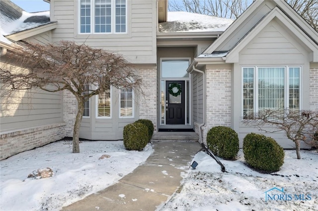 view of snow covered property entrance