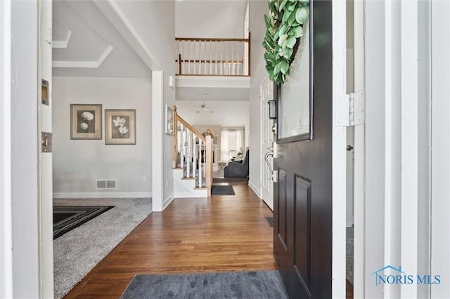 foyer with a high ceiling and dark hardwood / wood-style flooring