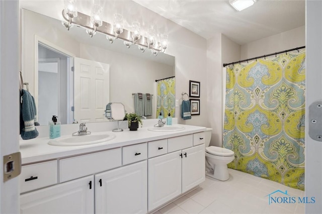 bathroom with vanity, tile patterned flooring, and toilet