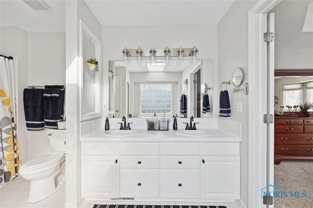 bathroom with a shower with curtain, vanity, plenty of natural light, and toilet