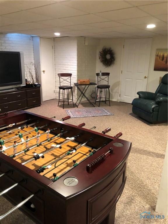 playroom featuring carpet and a paneled ceiling