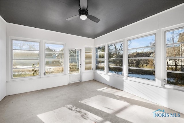 unfurnished sunroom featuring a wealth of natural light and ceiling fan