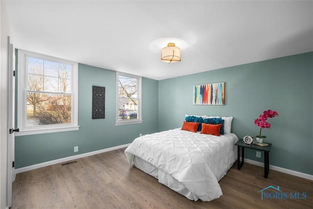 bedroom with hardwood / wood-style flooring