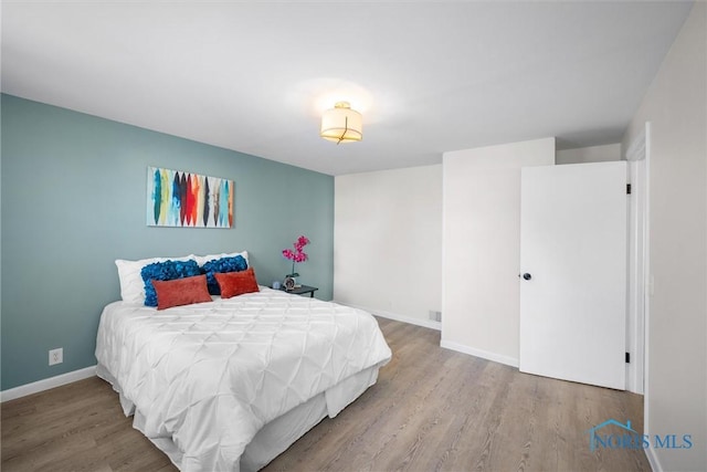 bedroom featuring wood-type flooring