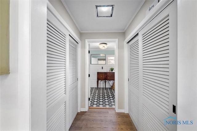 corridor featuring hardwood / wood-style floors and ornamental molding