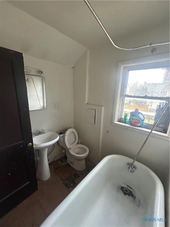 bathroom featuring toilet and a bath