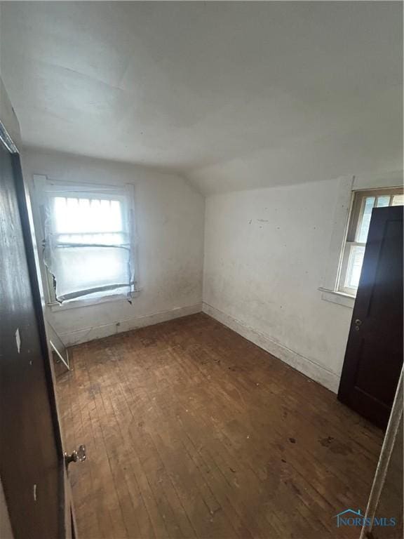 bonus room featuring lofted ceiling and dark wood-type flooring