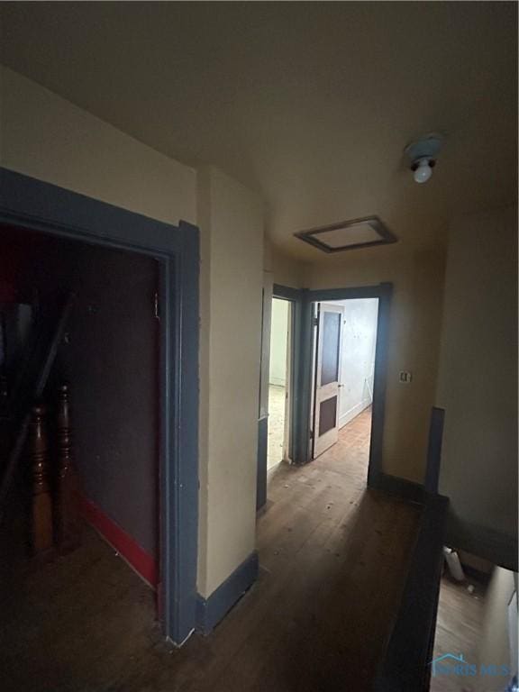 hallway with hardwood / wood-style flooring