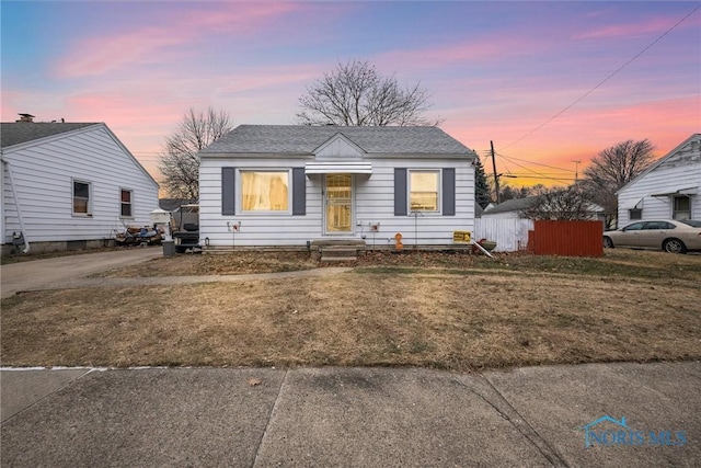 bungalow-style home with a lawn