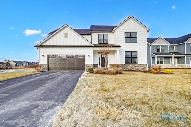 view of front of home with a garage and a front lawn