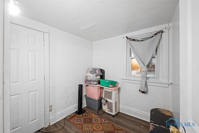 miscellaneous room featuring dark wood-type flooring