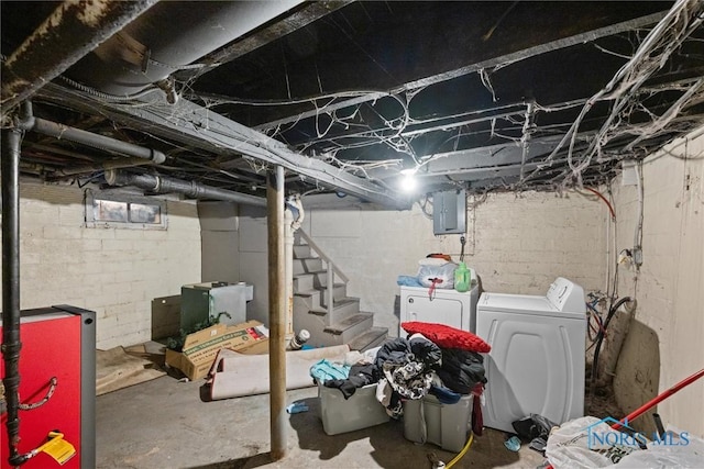 basement with washer and clothes dryer and electric panel