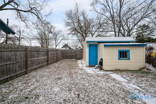 yard layered in snow featuring an outdoor structure