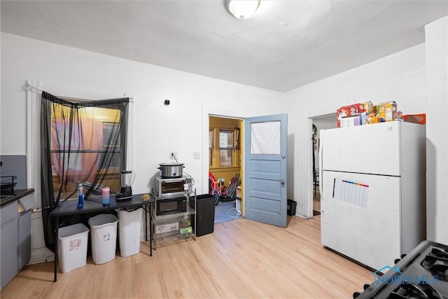 kitchen featuring white refrigerator and light wood-type flooring