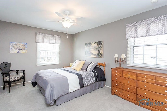 bedroom with light carpet and ceiling fan