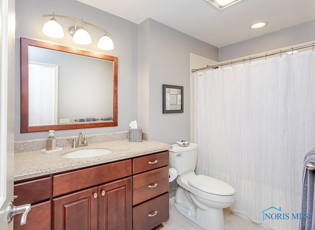 bathroom featuring tile patterned floors, vanity, and toilet