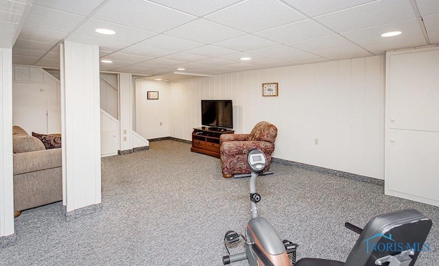 exercise room featuring carpet floors and a drop ceiling