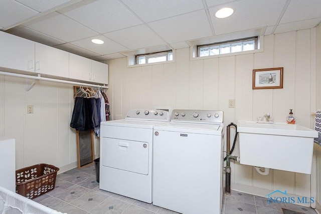 laundry room featuring cabinets, washing machine and dryer, plenty of natural light, and sink