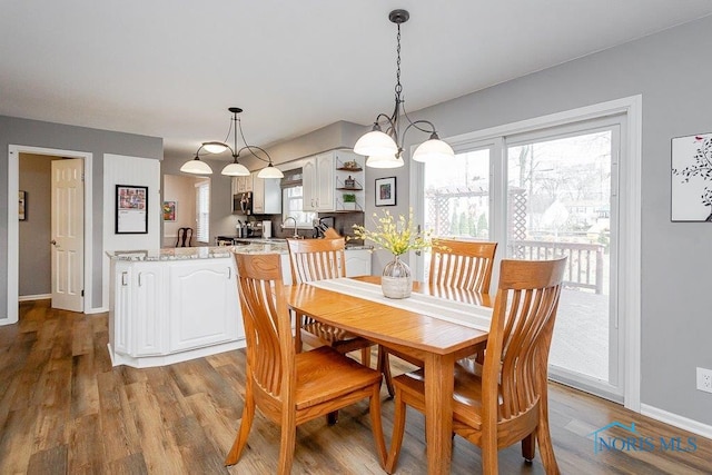 dining area featuring sink and light wood-type flooring