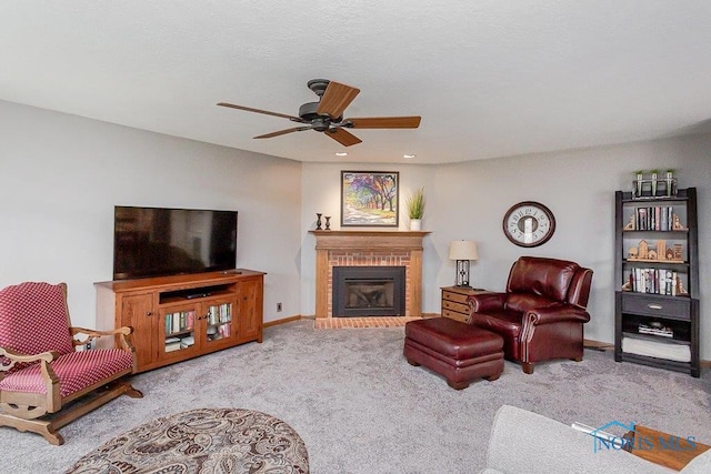 living room featuring ceiling fan, light colored carpet, and a fireplace